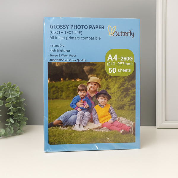 Butterfly Glossy Photo Paper packaging with a family photo on a white surface.