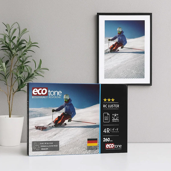 Framed photo of a skier on a snowy slope with eco-tone packaging and plant in the background.