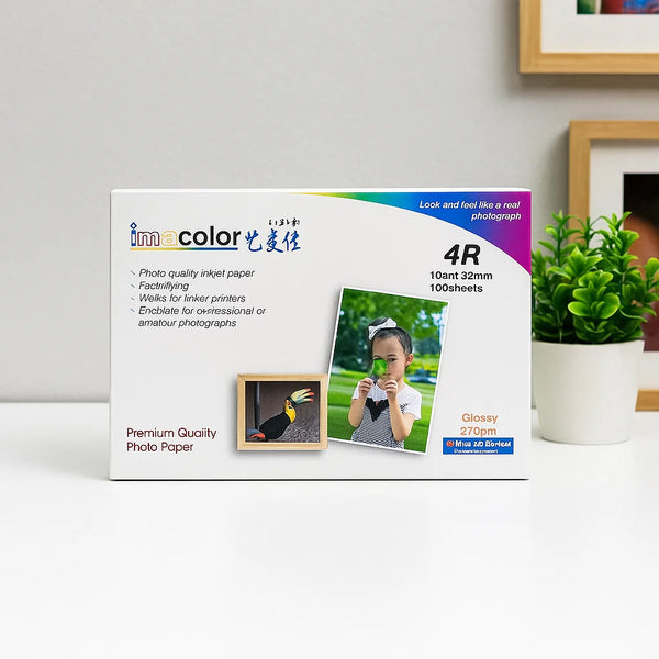 Box of photo paper with a child and bird image on a white surface