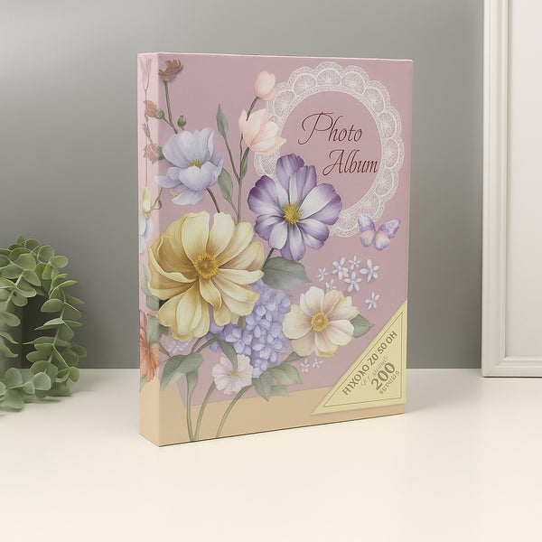Floral photo album with decorative cover on a neutral background