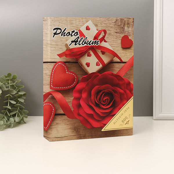 Photo album with wooden design, red rose, and hearts on a gray background