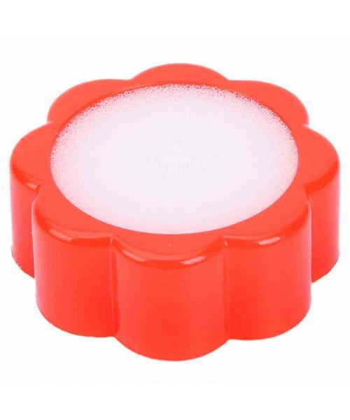 Red flower-shaped container with white substance on a white background