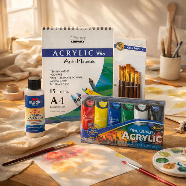Art supplies including acrylic paint, brushes, and paper on a wooden table.